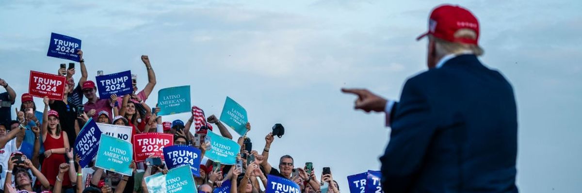 Donald Trump points at crowd of Trump supporters