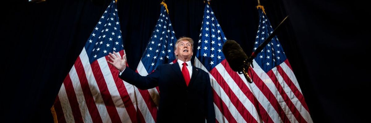 Donald Trump speaks on a stage.