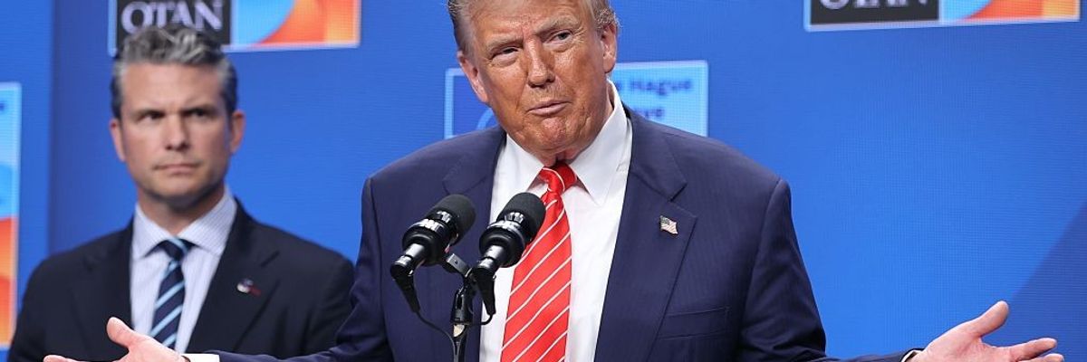 Donald Trump speaks while Pete Hegseth looks on