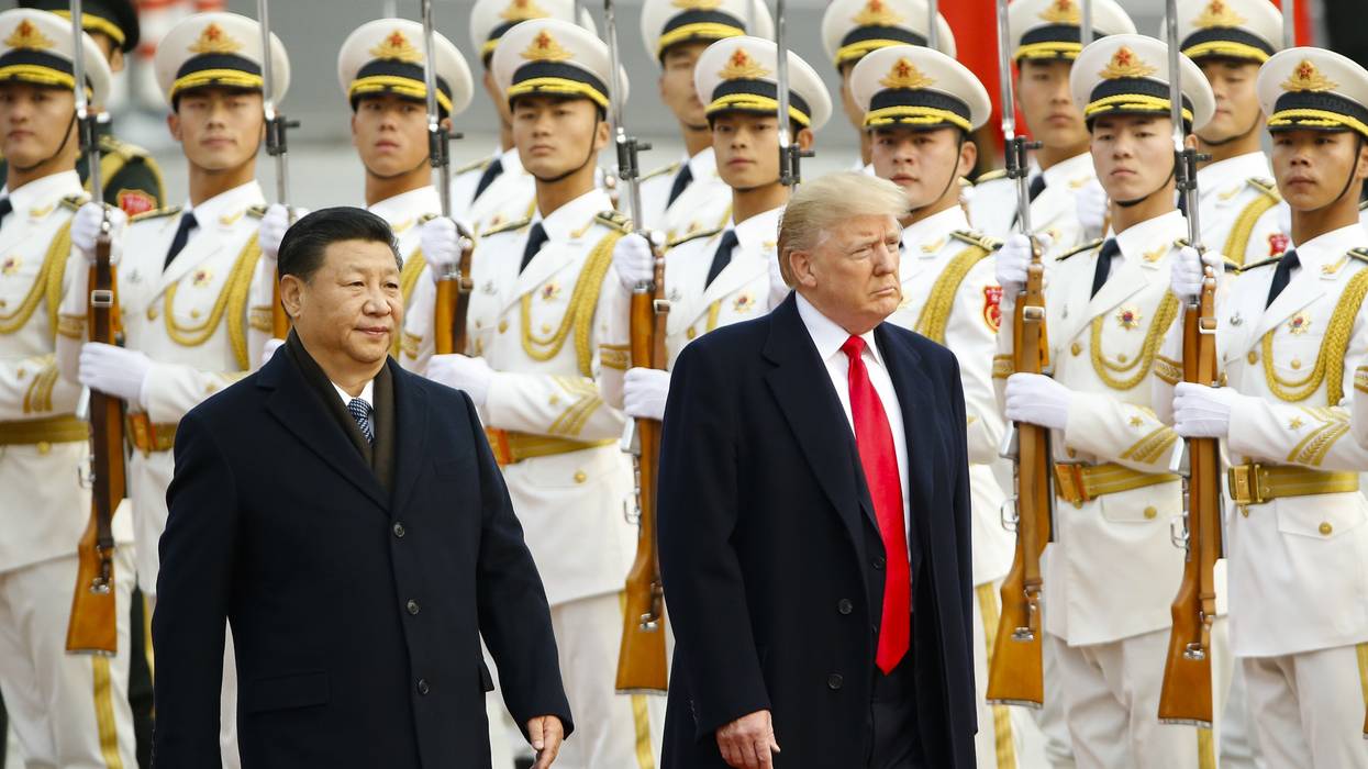 Donald Trump takes part in a welcoming ceremony with China's President Xi Jinping