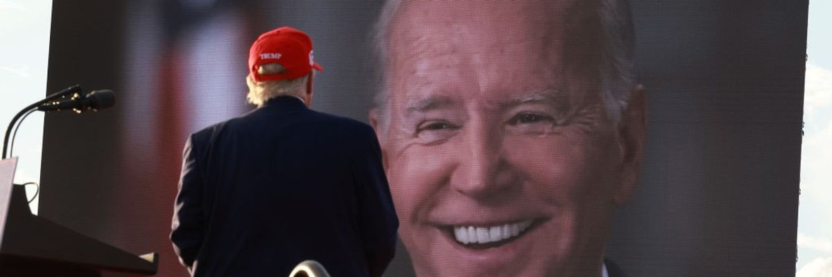 Donald Trump watching picture of Joe Biden on large screen
