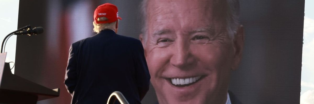 Donald Trump watching picture of Joe Biden on large screen