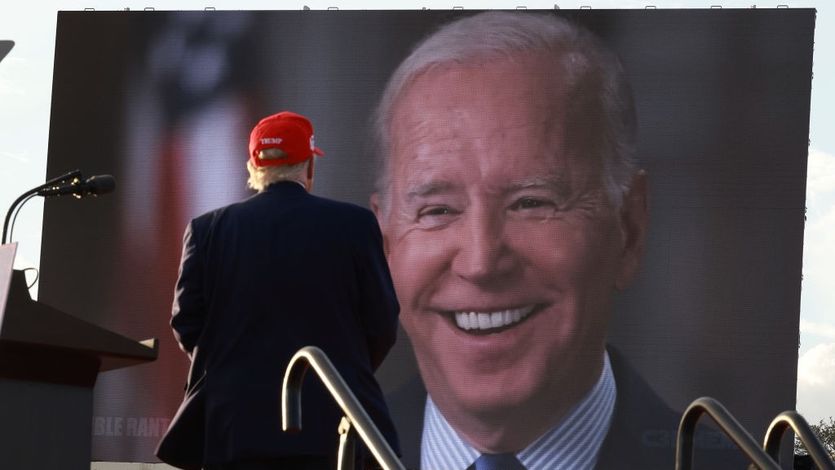 Donald Trump watching picture of Joe Biden on large screen