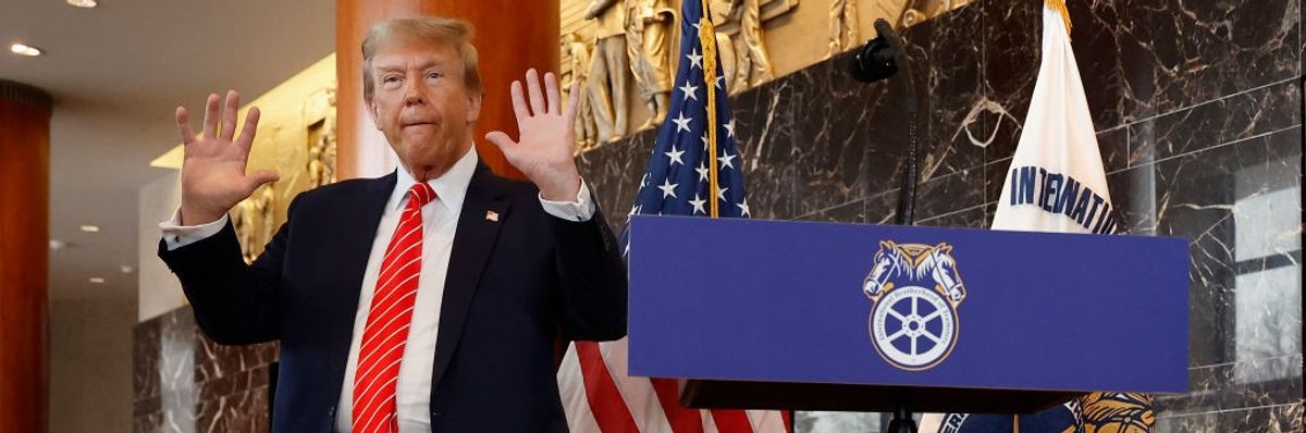 Donald Trump with hands up