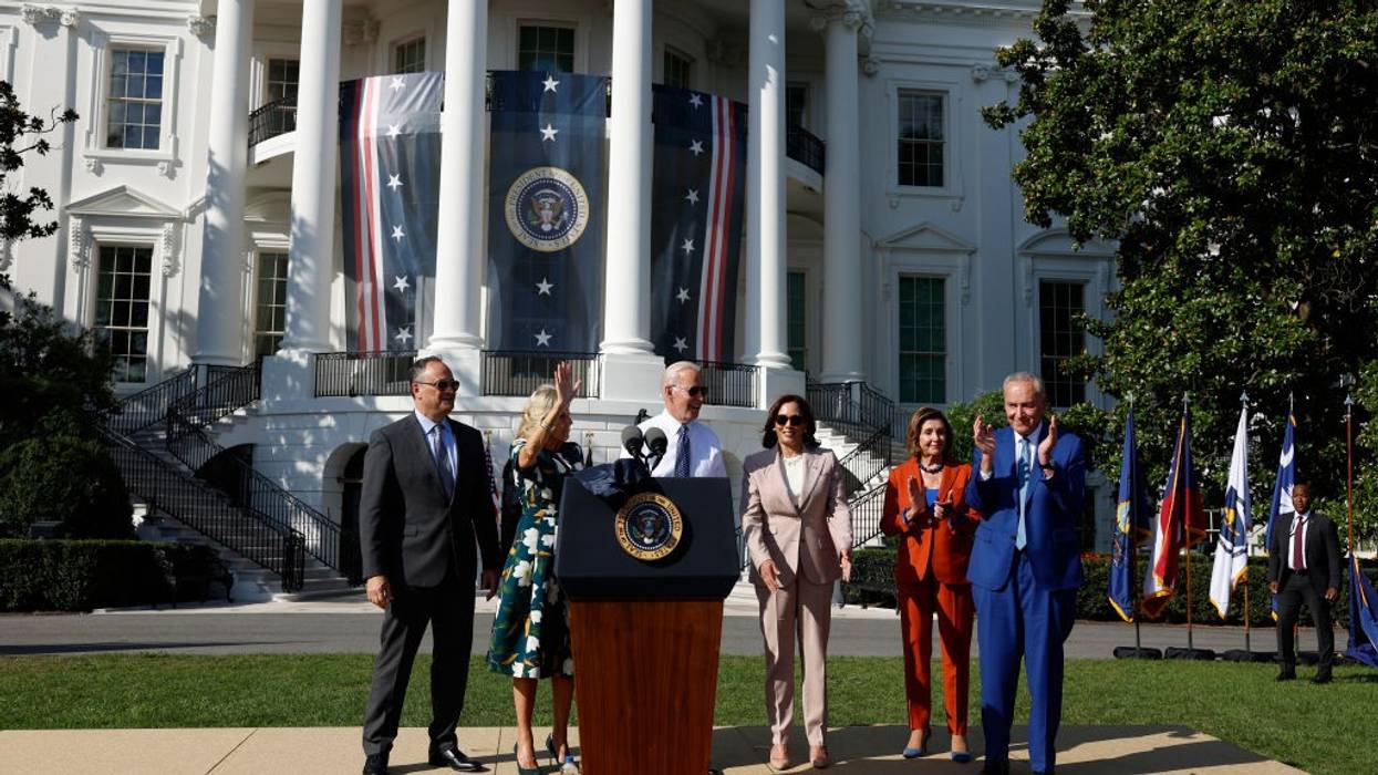 Doug Emhoff, Jill Biden, Joe Biden, Kamala Harris, Nancy Pelosi, and Chuck Schumer stand on the White House lawn.