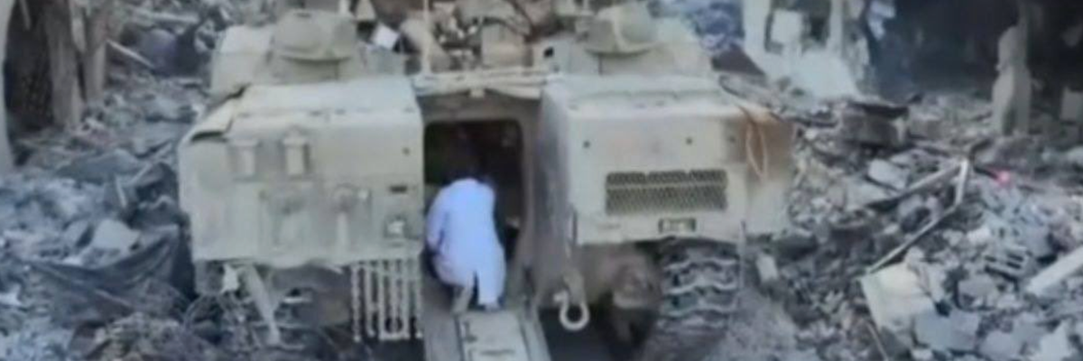 Dr. Hussam Abu Safiya approaches the entrance of an Israeli tank