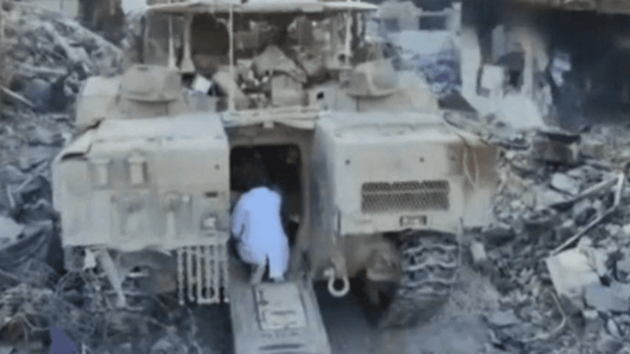 Dr. Hussam Abu Safiya approaches the entrance of an Israeli tank