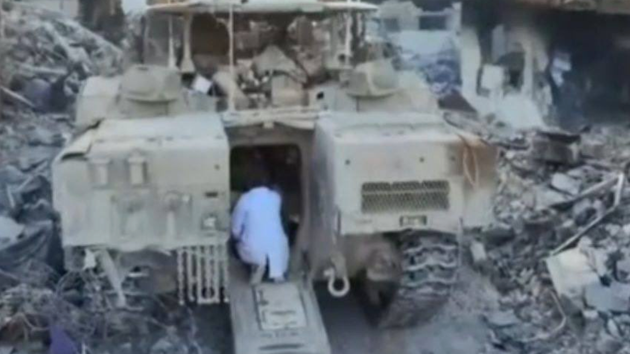 Dr. Hussam Abu Safiya approaches the entrance of an Israeli tank