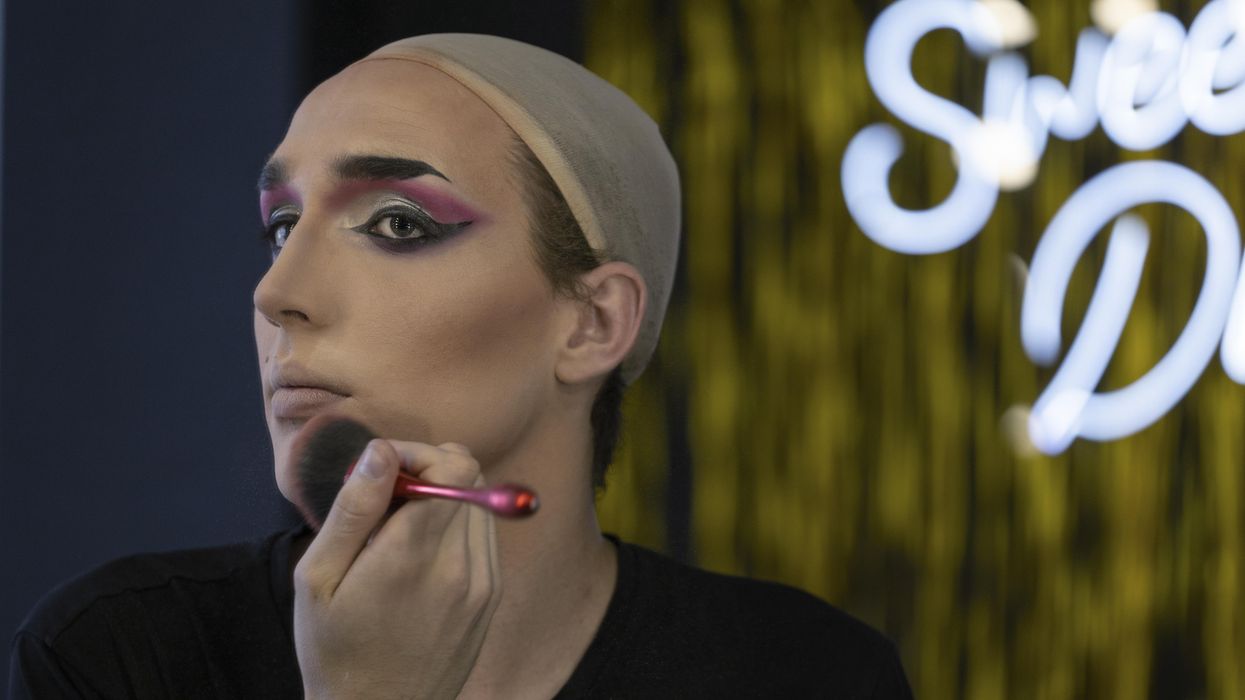 Drag performer applying makeup.