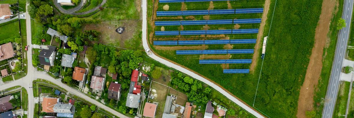 Drone view of small town and community solar array.