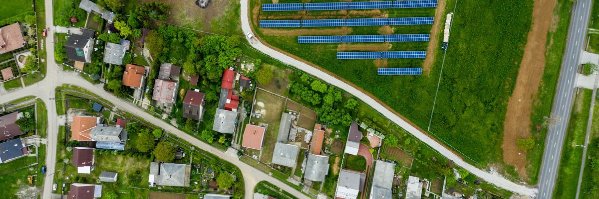 Drone view of small town and community solar array.
