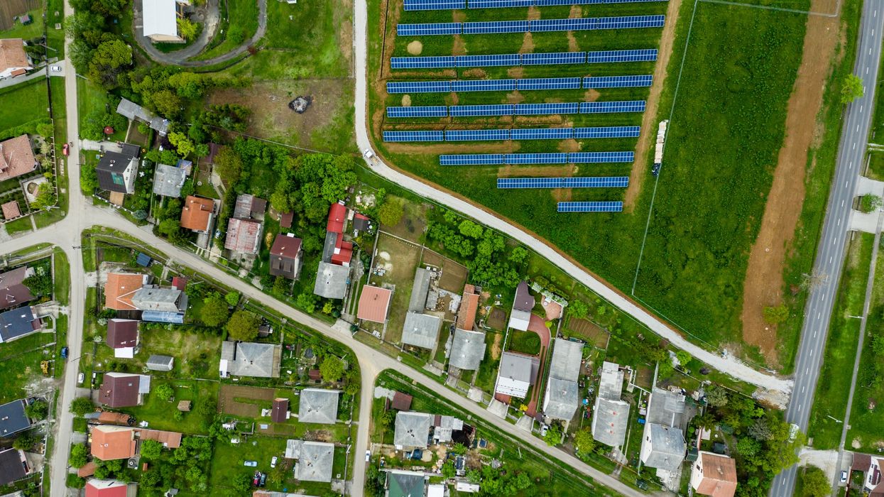 Drone view of small town and community solar array.