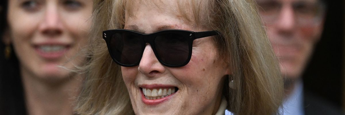 E. Jean Carroll walks out of courtroom smiling after a jury found Donald Trump liable for sexually assaulting and defaming her