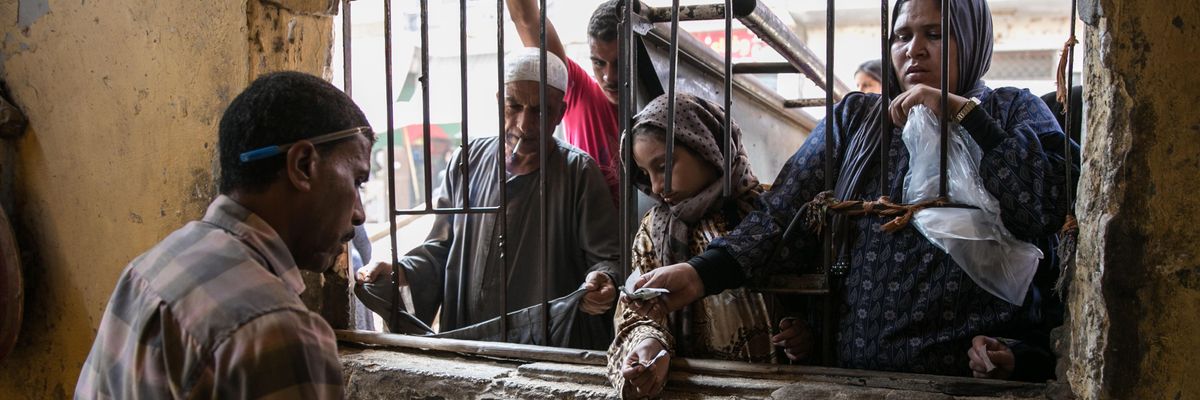 Egyptian women are seen as they buy bread from a bakery in Cairo, Egypt on September 23, 2014.