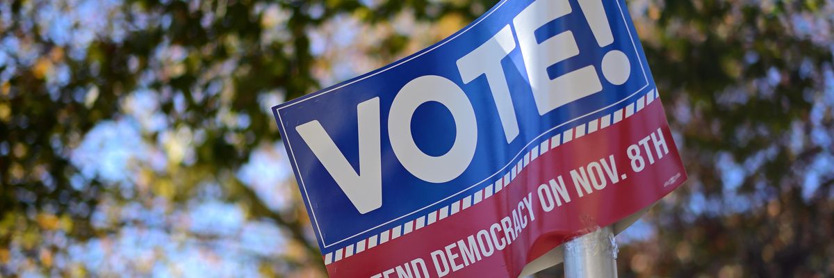 Election day signs says "VOTE! Defend Democracy on Nov. 8th"