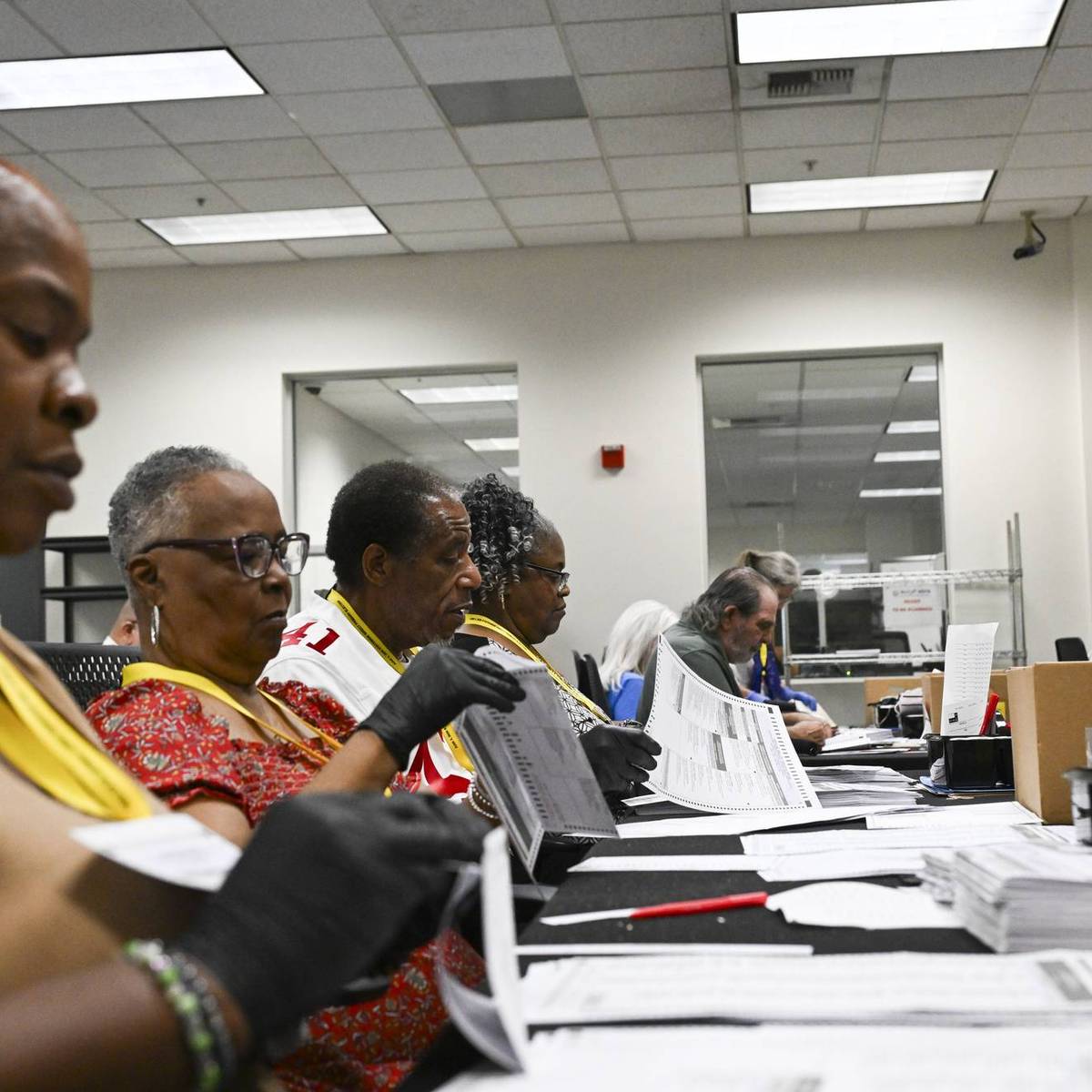 Election workers process mailed ballots in California