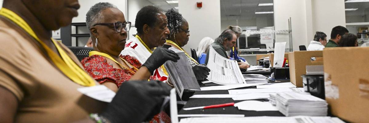 Election workers process mailed ballots in California