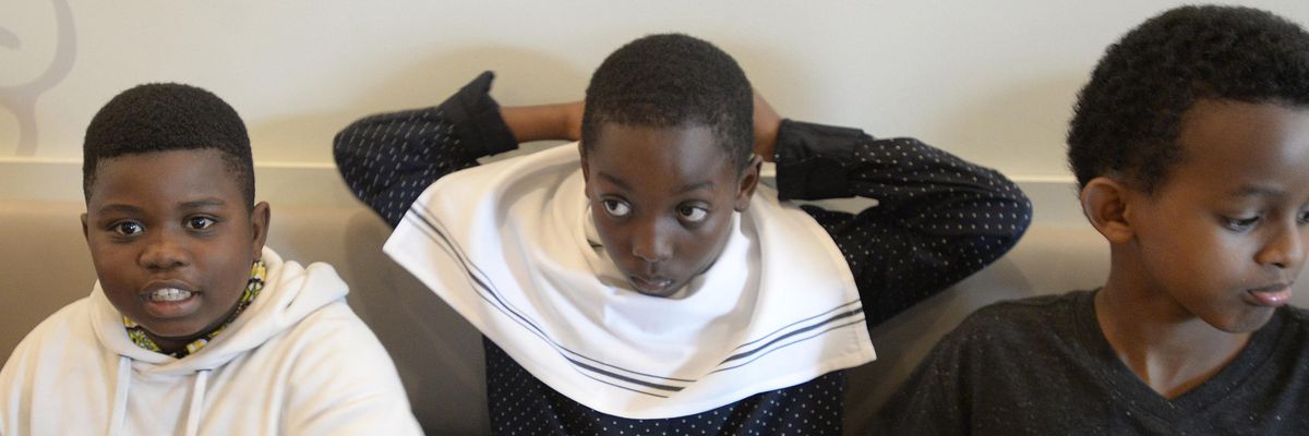 Eliel Otshudi places a napkin around his neck on June 6, 2018, in Portland, Maine.