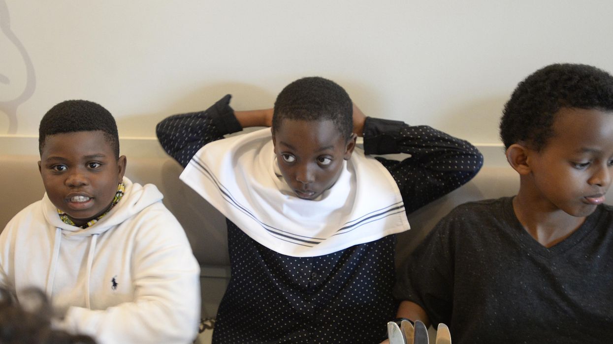 Eliel Otshudi places a napkin around his neck on June 6, 2018, in Portland, Maine.