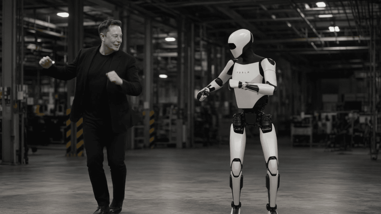 Elon Musk dances with a robot