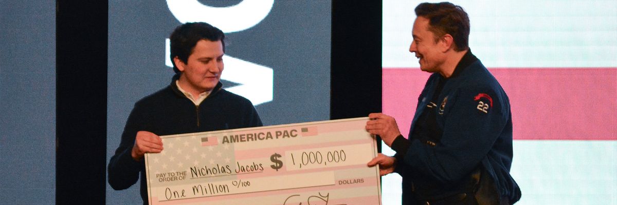 Elon Musk gives a $1 million check made to the order of Nicholas Jacobs