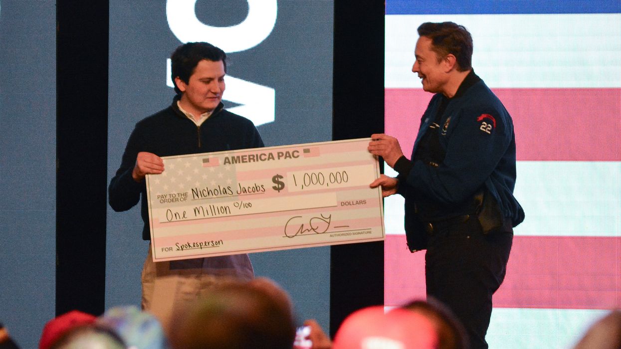 Elon Musk gives a $1 million check made to the order of Nicholas Jacobs
