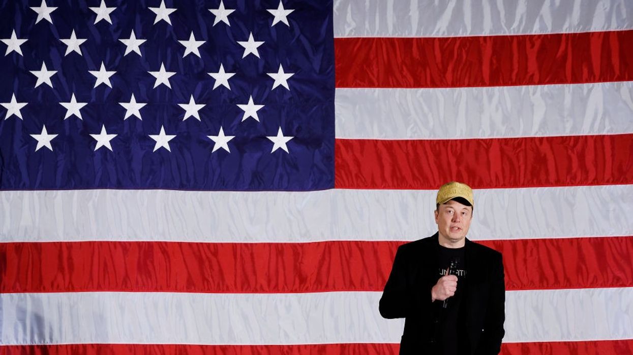 Elon Musk in front of American flag