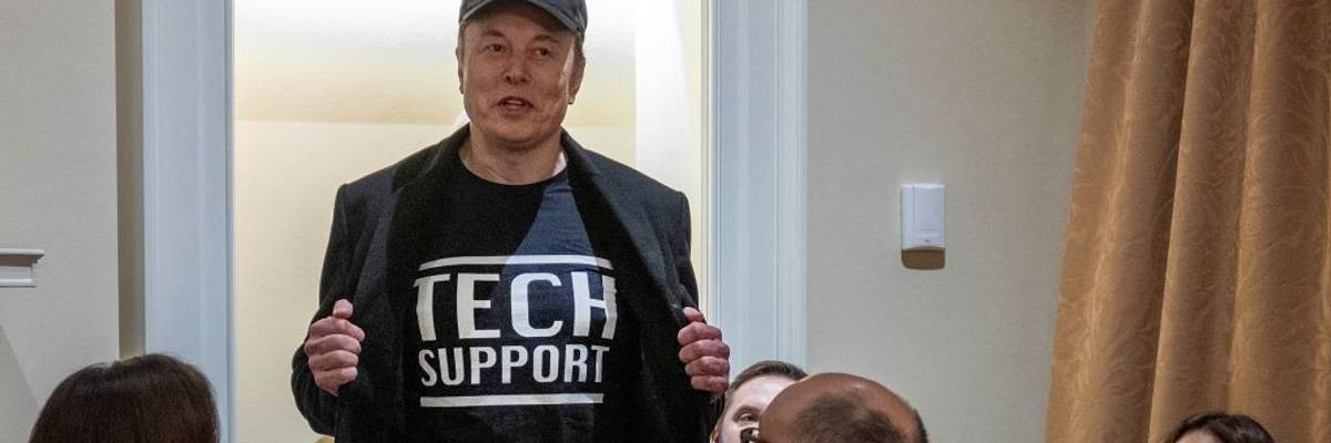 Elon Musk in Tech Support shirt.