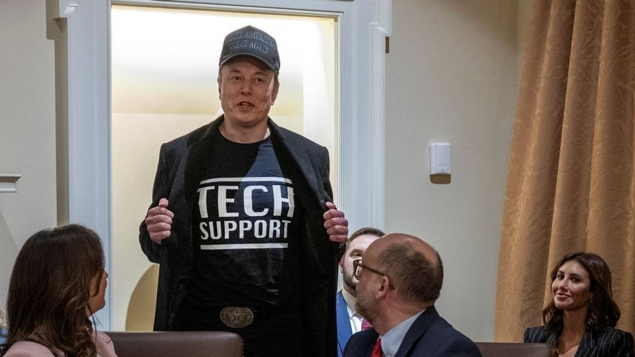 Elon Musk in Tech Support shirt.