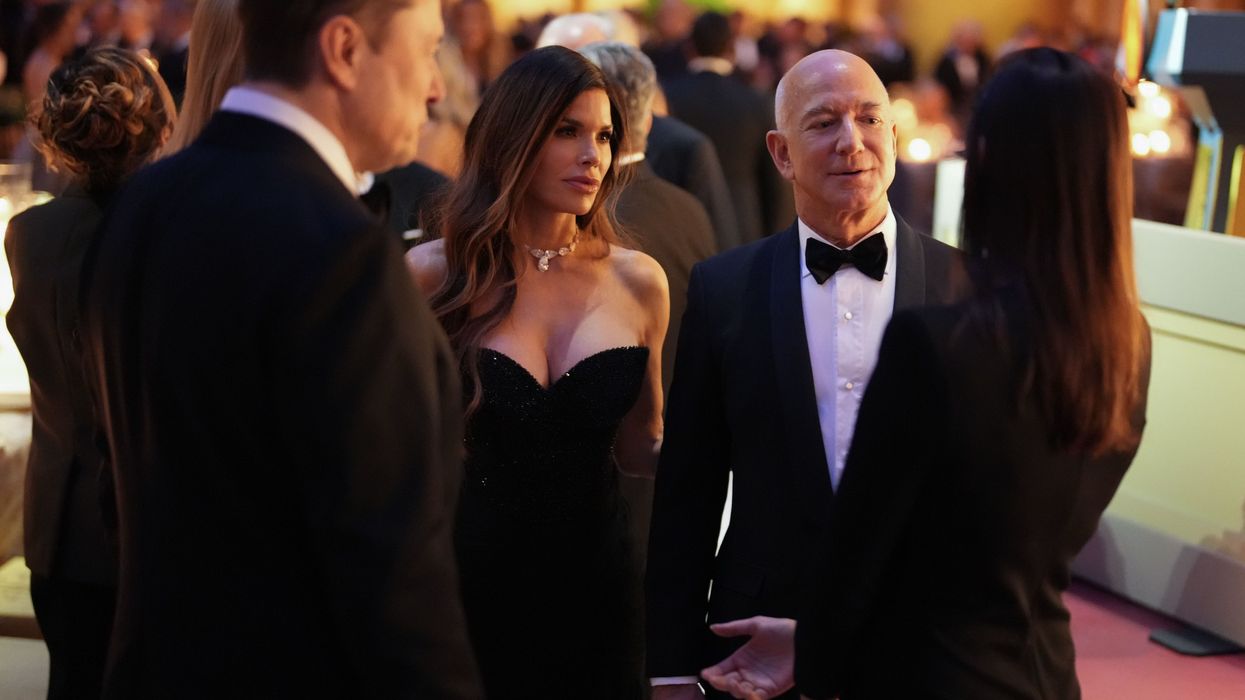 Elon Musk, left, Lauren Sanchez, and Jeff Bezos attend a candlelight dinner