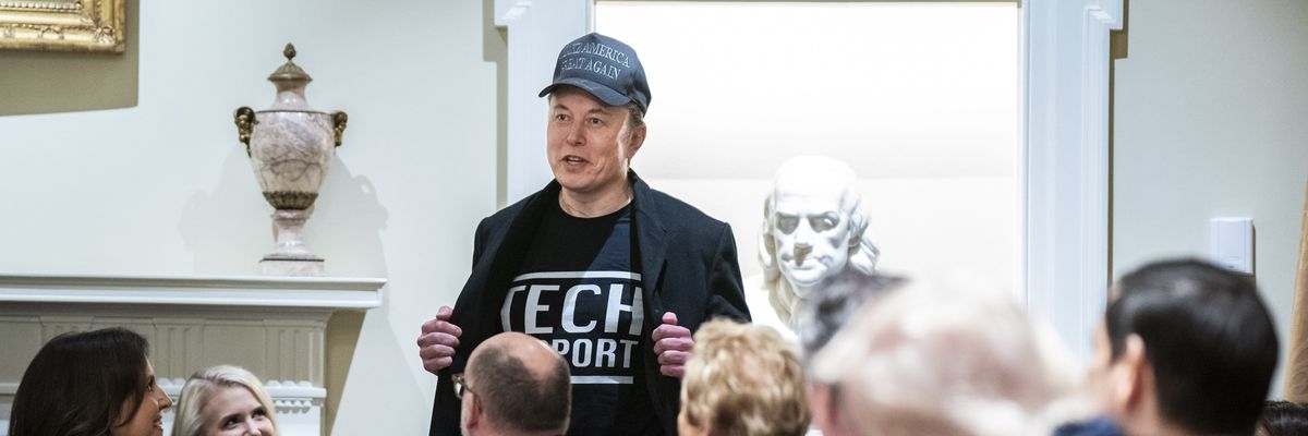 Elon Musk shows off a shirt that says "Tech Support"