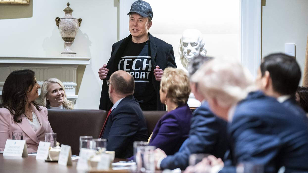 Elon Musk shows off a shirt that says "Tech Support"