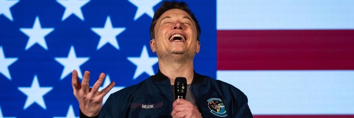 Elon Musk smiling in front of American Flag