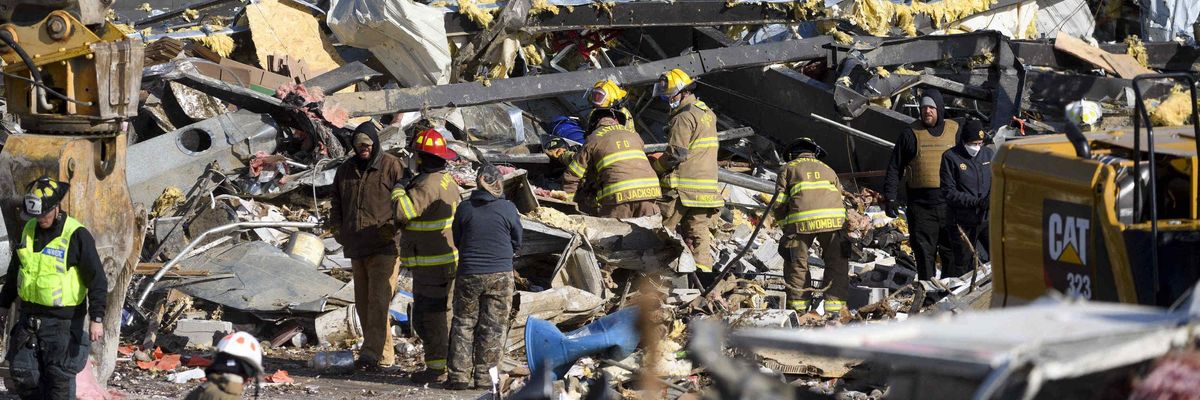 Emergency workers search through what is left of the Mayfield Consumer Products Candle Factory after it was destroyed by a tornado in Mayfield, Kentucky, on December 11, 2021