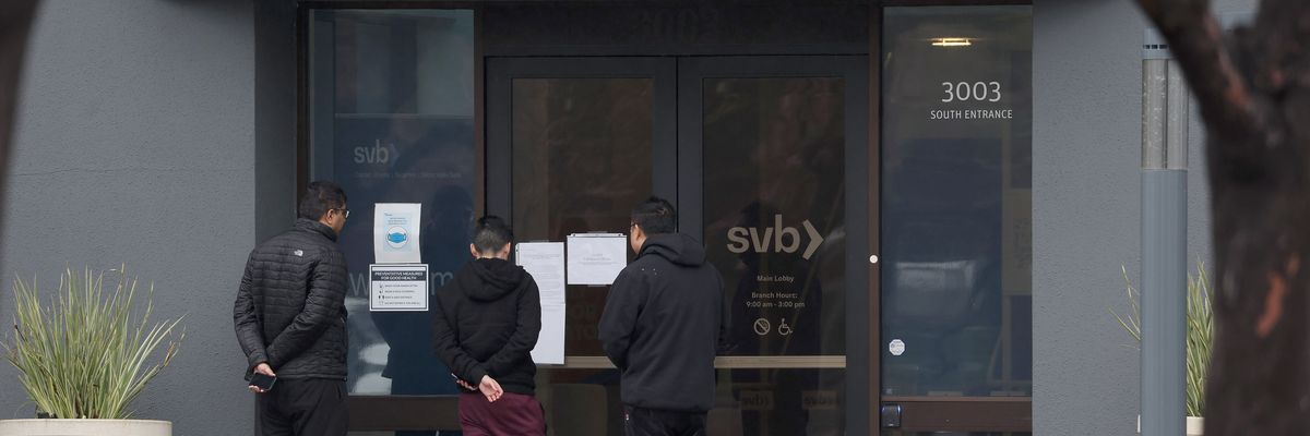 Employees stand outside of the shuttered Silicon Valley Bank (SVB) headquarters
