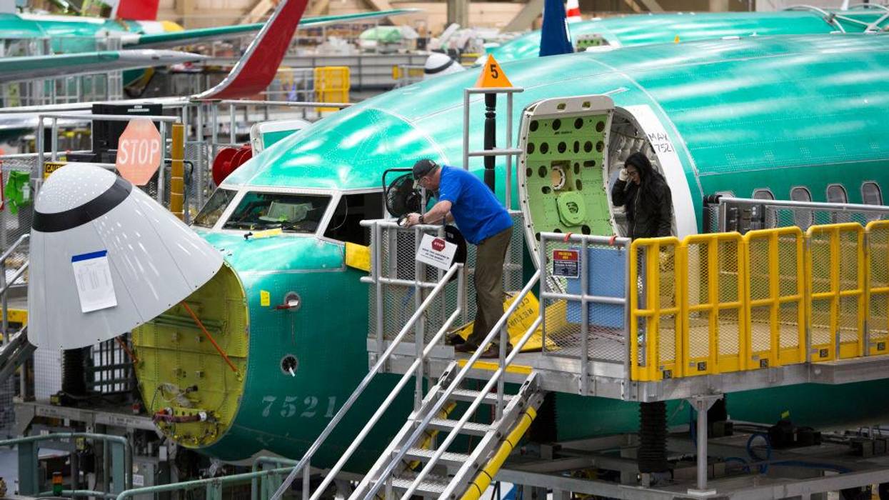 Employees work on Boeing 737 Max airplanes at a factory in Renton, Washington on March 27, 2019.