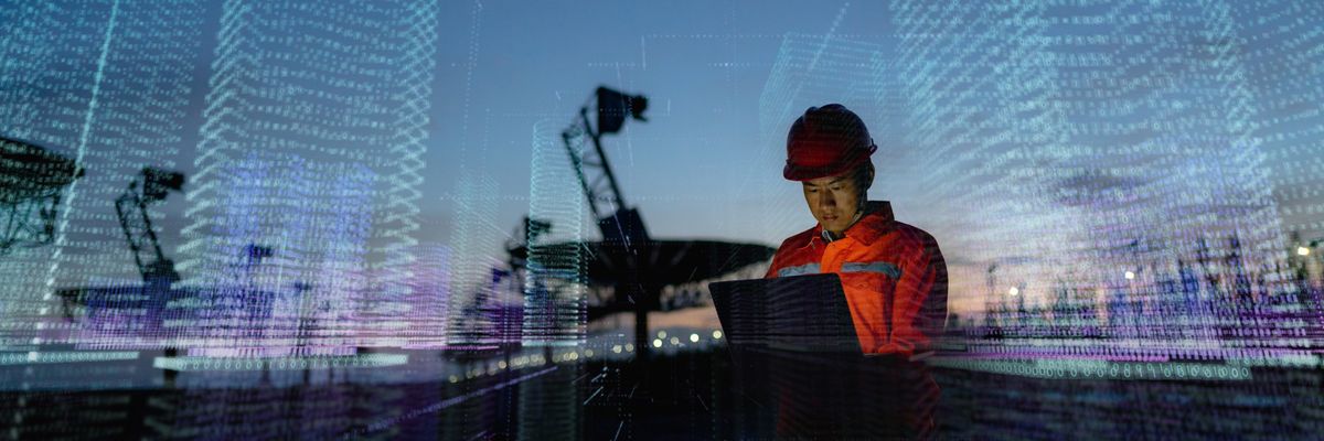 Engineer using laptop computer, futuristic technology