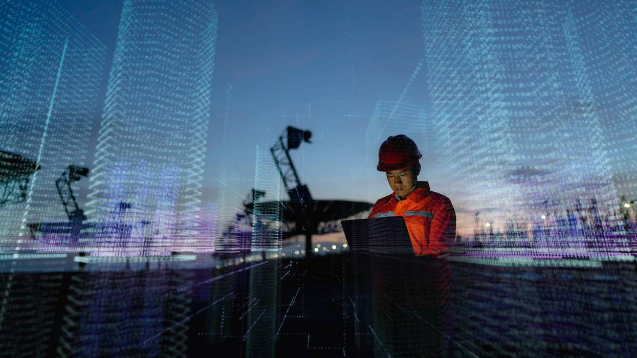 Engineer using laptop computer, futuristic technology