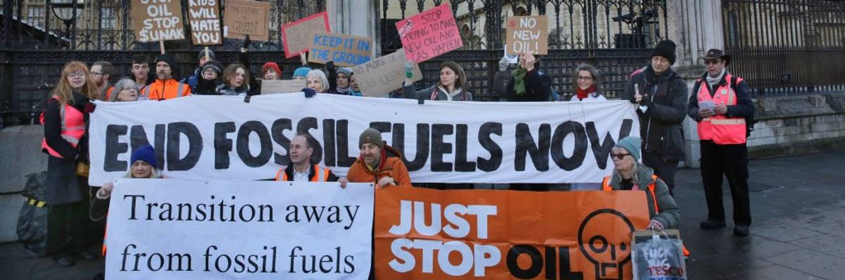 environmental protesters gathering with placards