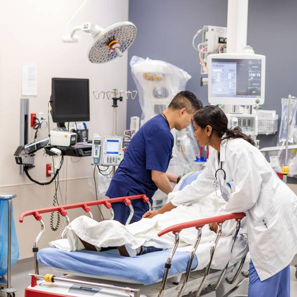 ER doctor and nurse prepare unconscious woman for examination