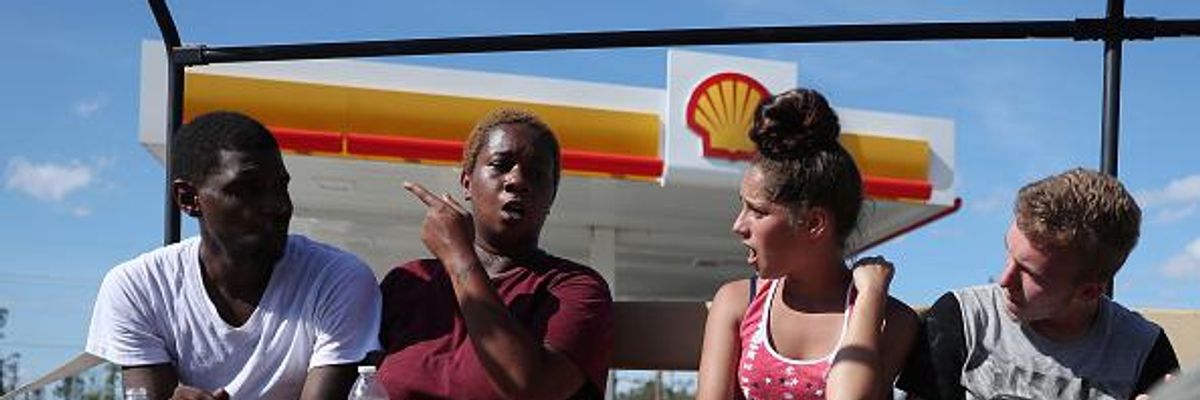 Evacuees sit in the back of a Louisiana National Guard truck waiting to leave after Hurricane Laura passed through the area on August 27, 2020 in Lake Charles, Louisiana.