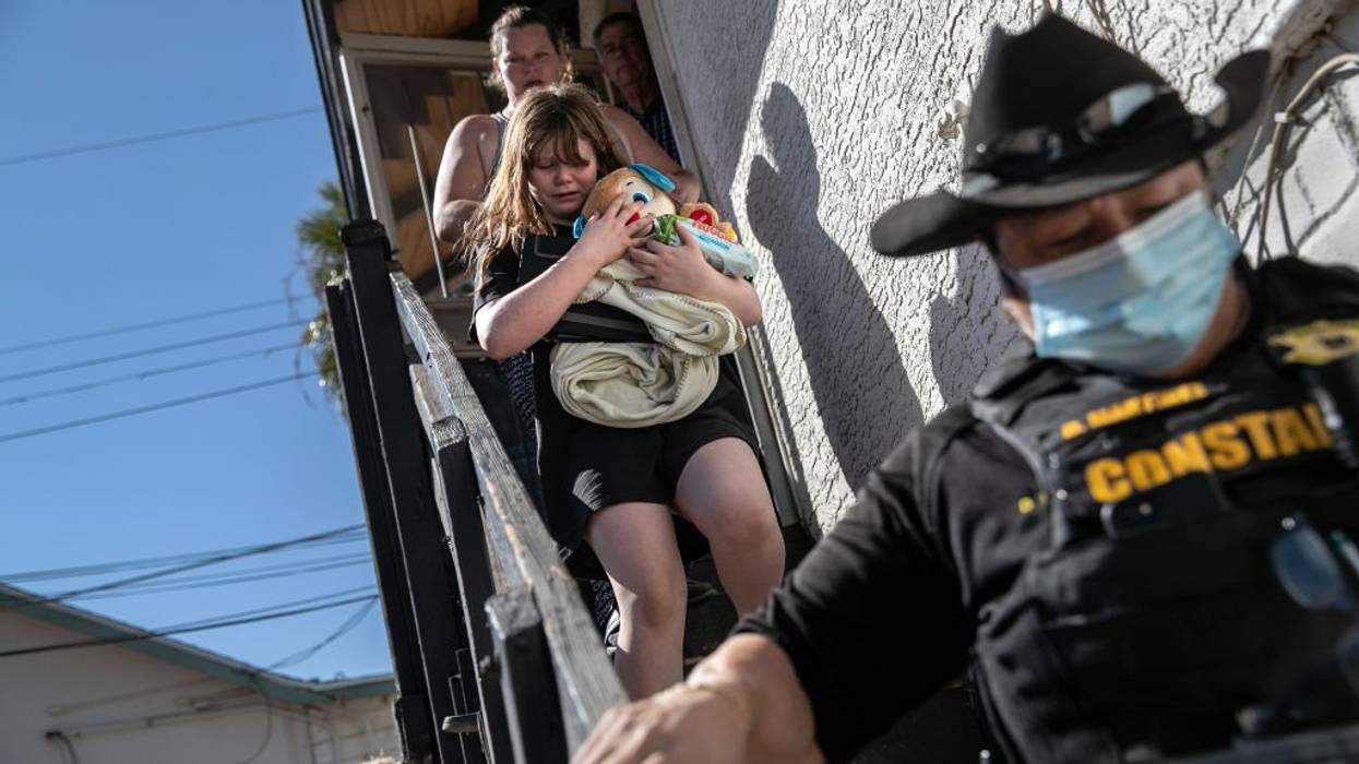 Evicted family being escorted by sheriff