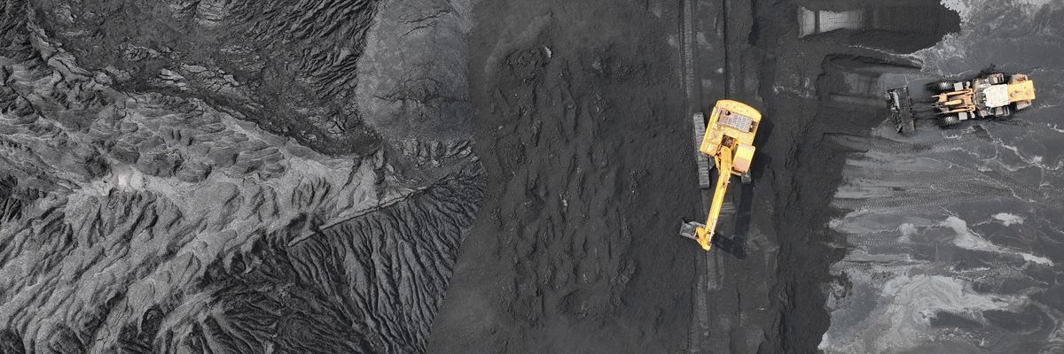 Excavators pile coal at Lianyungang Port on July 29, 2022 in Lianyungang, Jiangsu Province of China. 