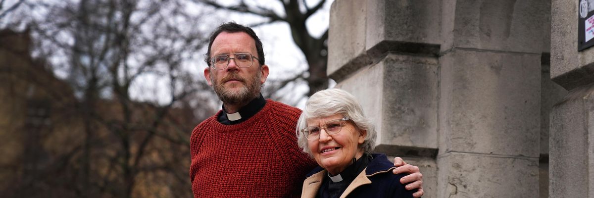 Extinction Rebellion activists Father Martin Newell and Reverend Sue Parfitt stand outside Inner London Crown Court on January 10, 2022.
