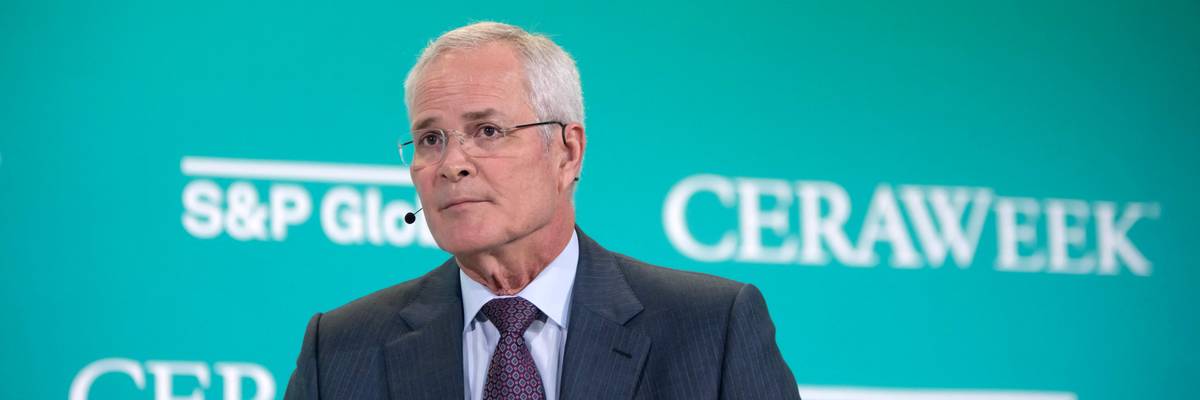Exxon CEO Darren Woods speaks at an international energy conference