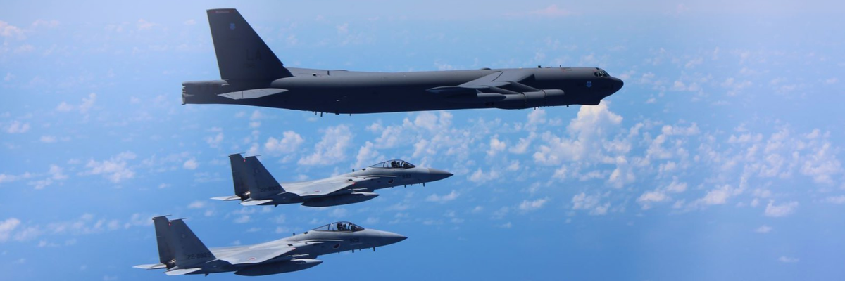 F-15 fighters escort a B-52 bomber