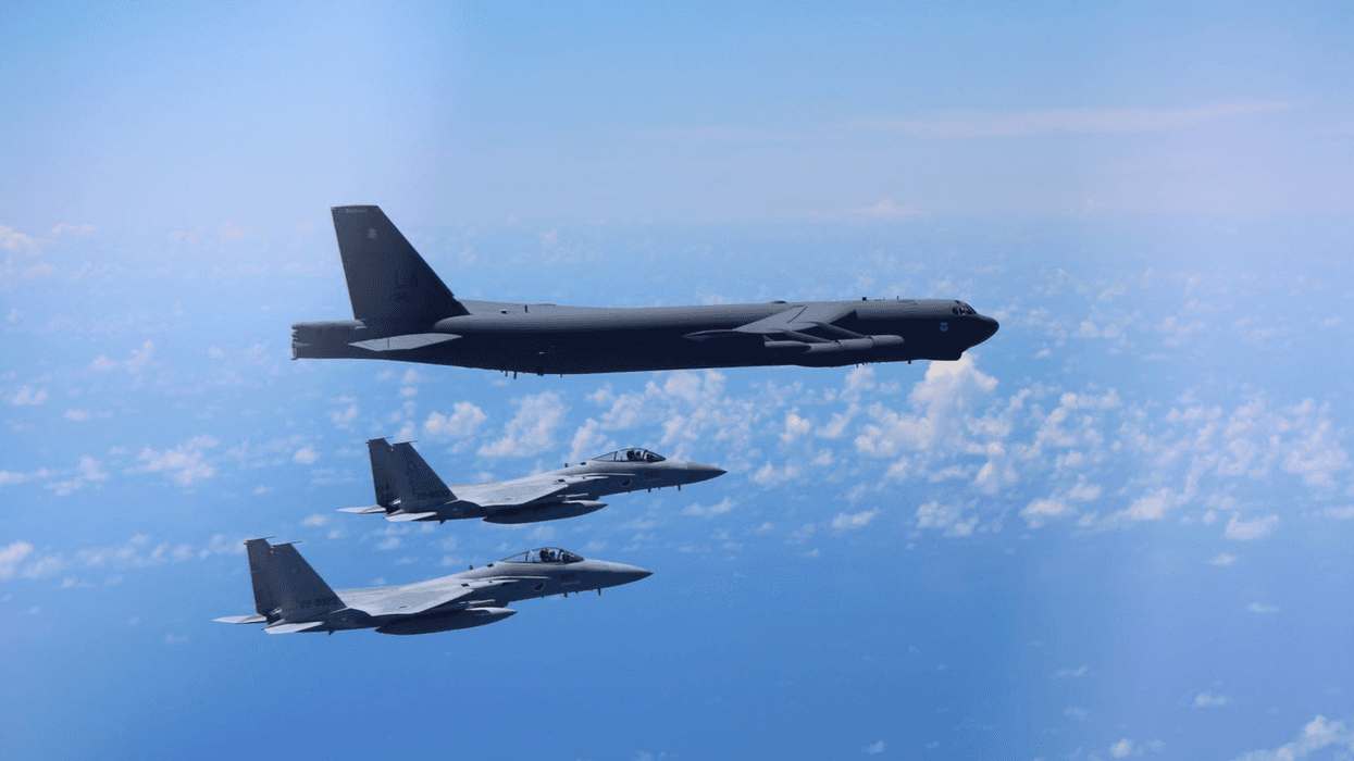 F-15 fighters escort a B-52 bomber