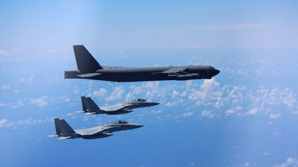 F-15 fighters escort a B-52 bomber