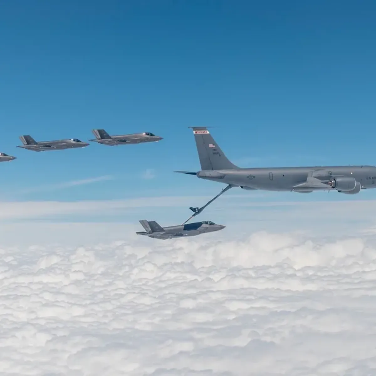 F-35s fly, with one refuelling