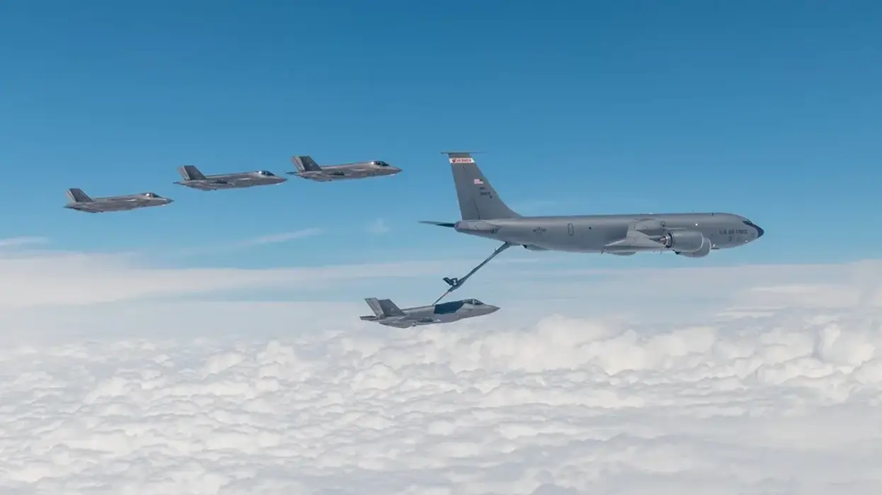 F-35s fly, with one refuelling